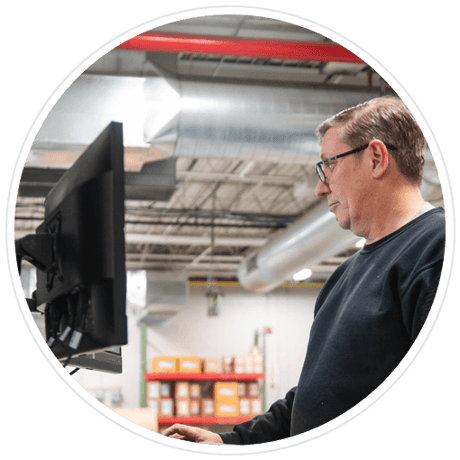 Press operator looking at computer monitor