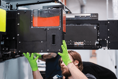 Press operator working on commercial printing press